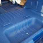 Cab of Jeep lined with blue bedliner